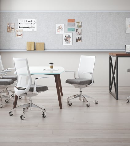 . An organized white office interior showcasing a table and chairs, designed for a functional and inviting work environment.