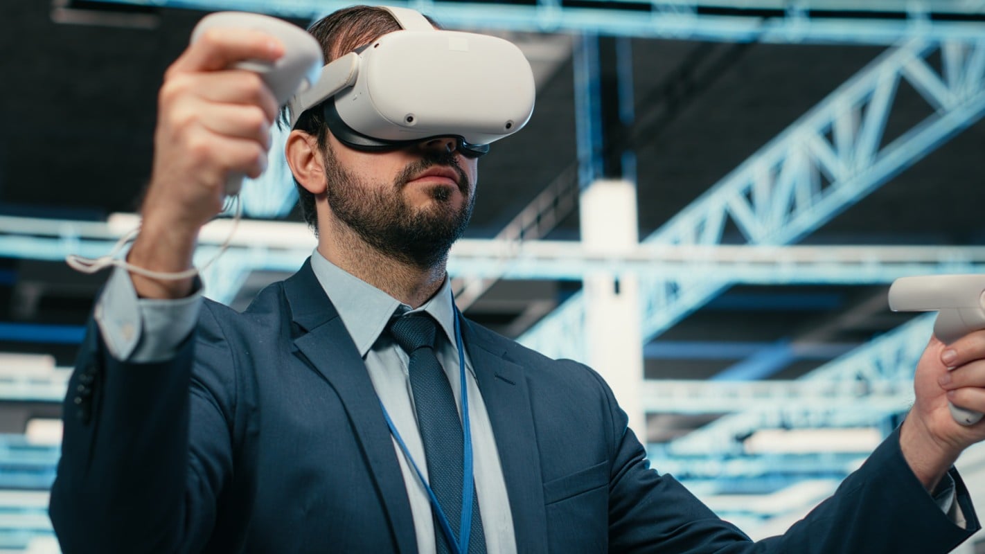 A man in a suit and tie holds a virtual reality headset, showcasing a blend of professionalism and technology.