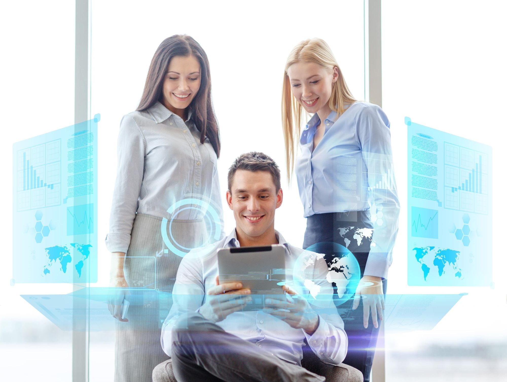 A group of three professionals, two women and one man, are engaging with digital data and analytics on a tablet, surrounded by holographic displays of graphs and world maps.